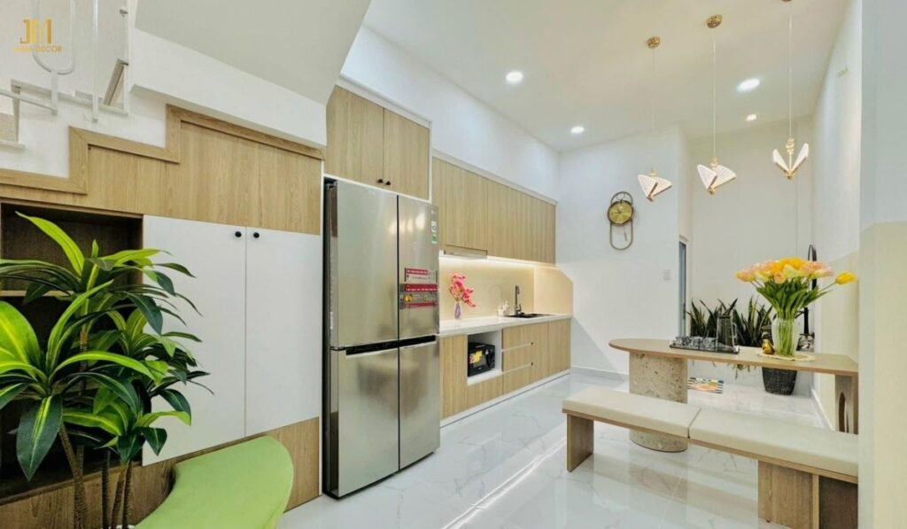 Sự kết hợp hài hòa giữa màu trắng và vân gỗ nhạt tạo nên không gian bếp gọn gàng, tinh tế